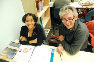 A volunteer tutor working with a young student